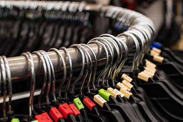 Hanger Many hangers on a rack in the store. clothes hanger rod stock pictures, royalty-free photos & images