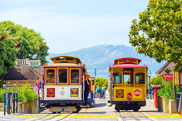 San Francisco, United States - May 19, 2016: Tourists wait at terminal cable car turnaround station, the end of the line at Hyde Street, Fisherman's Wharf with Marin Headlands in background. Horizontal