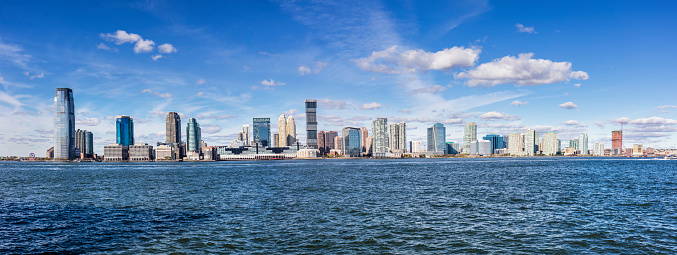 Panoramic view of urban skyline of Newport, Jersey city. Modern buildings are against blue sky. Travel locations.