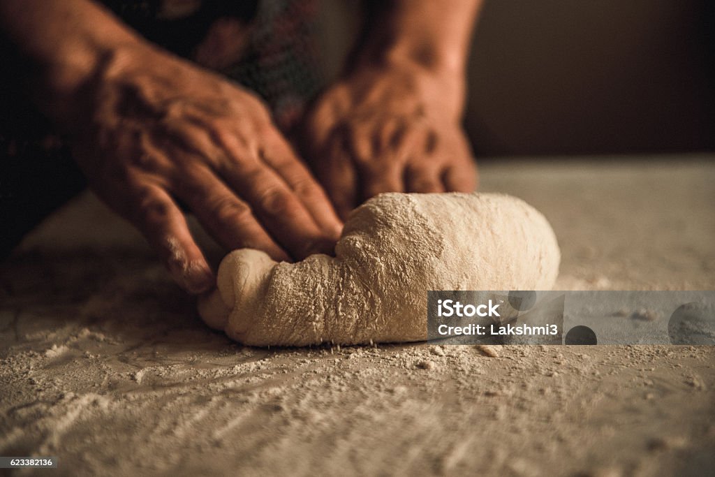knead the dough by hand woman knead the dough by hand on pies Bread Stock Photo