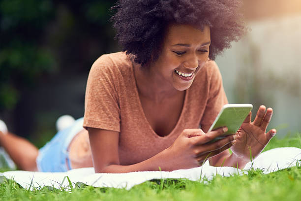 istock The park is the perfect spot for a good e-book 623383024