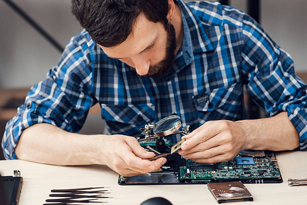 istock Bearded repairman disassemble computer motherboard 623383766