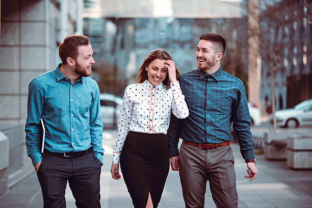 smiling young students walking on the street and talking - casual shirt imagens e fotografias de stock