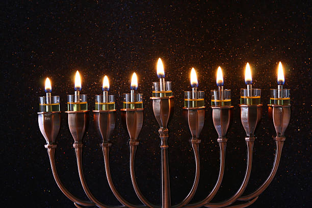 istock jewish holiday Hanukkah background with menorah 623384688