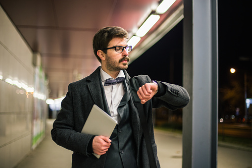 Formal wear businessman looking what time it is