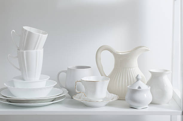 istock Clean dishes and vases on white wooden shelf 623384994