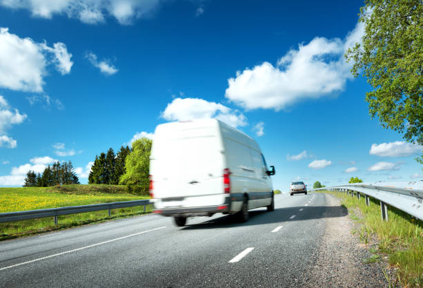 istock asphalt road on dandelion field 623385154