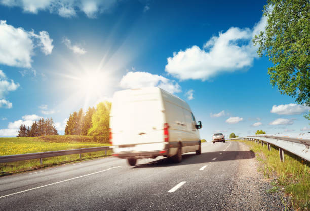 istock asphalt road on dandelion field 623385244