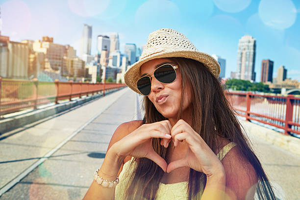 Shot of a smiling young woman walking around the city in the summertime