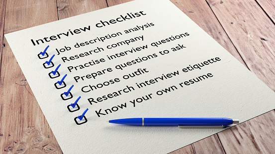 Interview checklist blue pen on wooden table