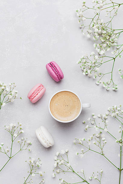 istock Macarons with coffee, decorated flowers. Flat lay. Vintage mockup. 623422752