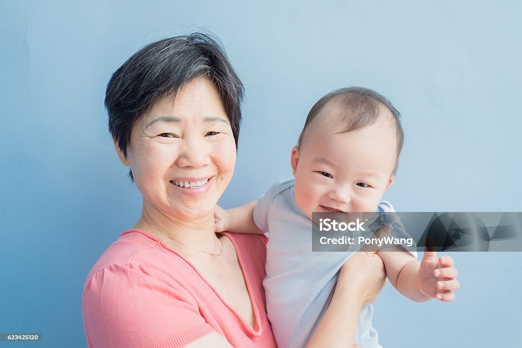 grandmother hug her grandson happily grandmother hug her grandson happily,asian Blue Background Stock Photo