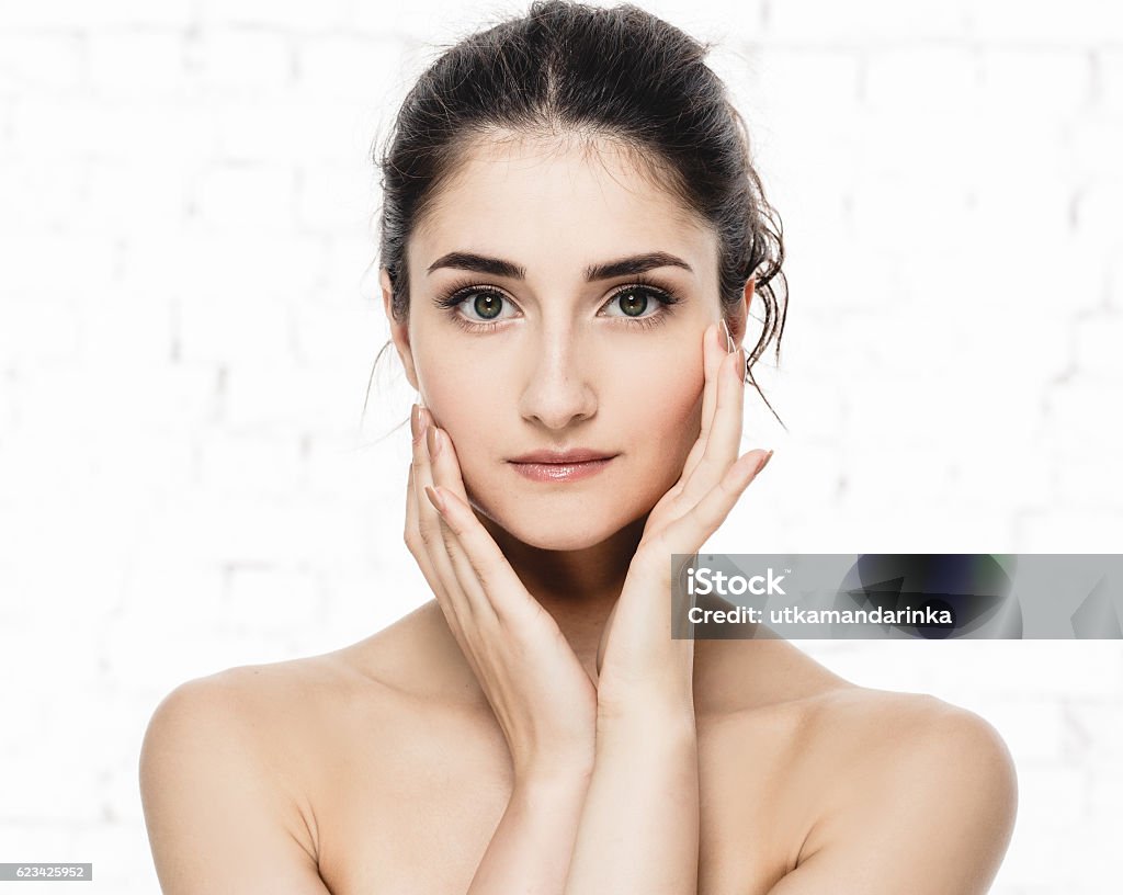 Beauty Woman face with perfect skin Portrait. Isolated on white. Beauty Woman face Portrait. Beautiful model Girl with Perfect Fresh Clean Skin. Youth and Skin Care Concept. Isolated on a white background Artist's Model Stock Photo