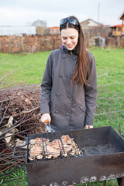 istock young woman and barbecue 623426230