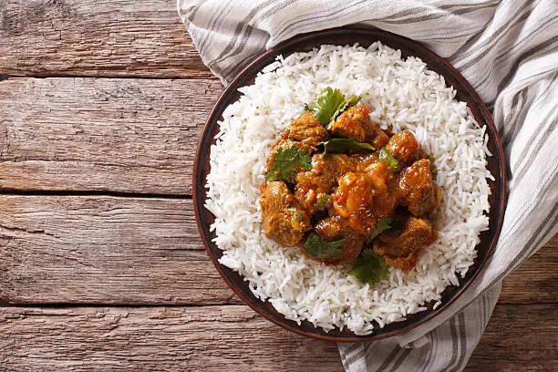 Photo of Indian food: Madras beef with basmati rice. Horizontal top view