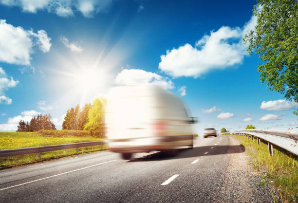 istock asphalt road on dandelion field 623426822