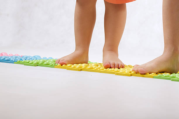 istock Childrens feet on a orthopaedic mat 623430284