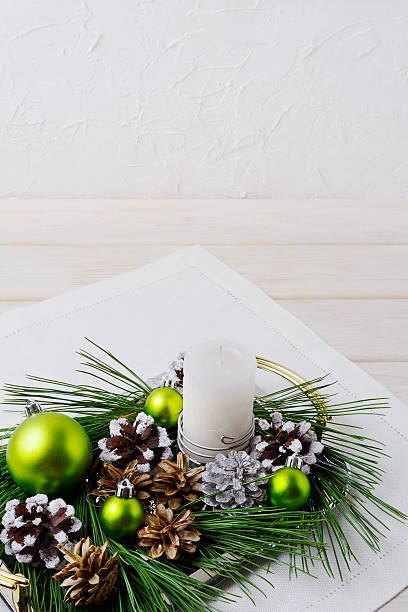 istock Christmas background with snowy pinecone and green ornaments 623430542