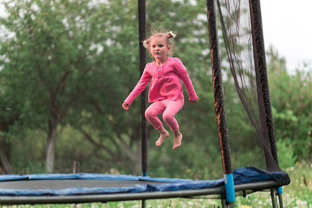 istock Little girl jumping on the trampoline 623433158