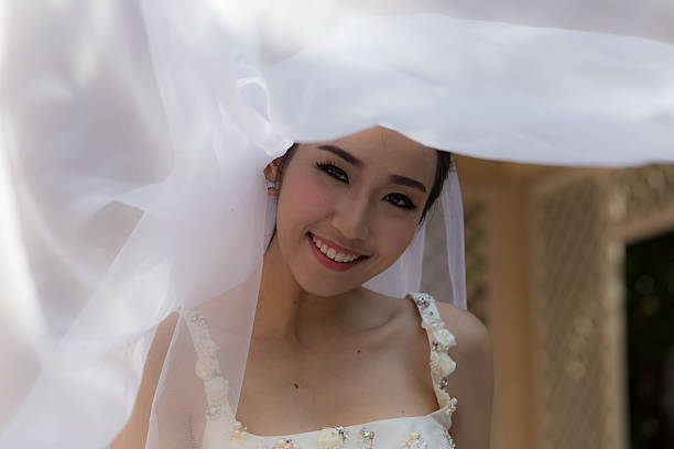 istock Beautiful Asian bride smiling 623433602