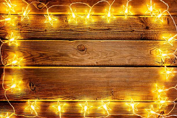 istock Christmas lights on wooden rustic background. 623434450