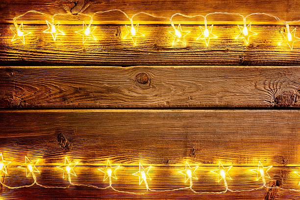istock Christmas lights on wooden rustic background. 623435092