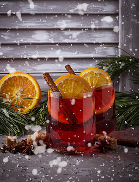 istock Glasses of mulled wine with orange and cinnamon, snow effect 623436224