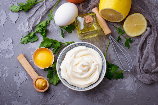 Homemade mayonnaise sauce and olive oil, eggs, mustard, lemon. Selective focus