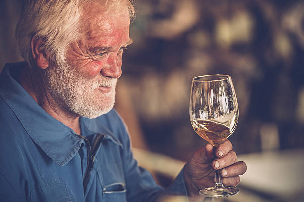istock Senior Man with Beard Drinking Glass of White Wine 623437170