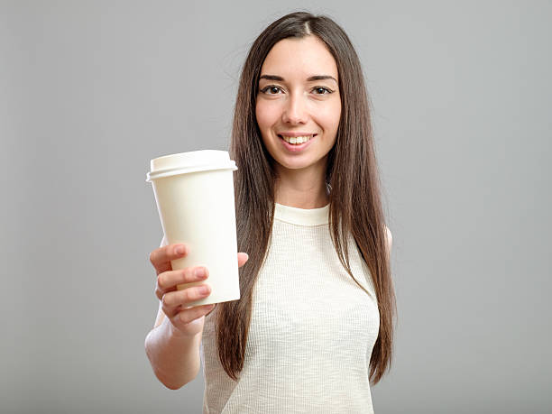 istock Woman offering white cup of coffee 623437254