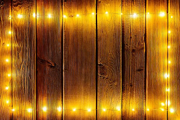 istock Christmas lights on wooden rustic background. 623437552