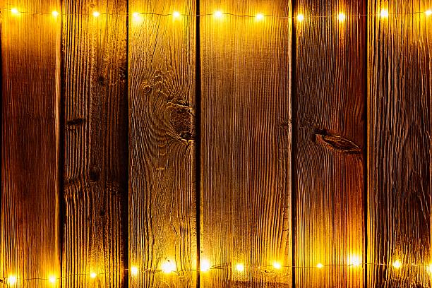 istock Christmas lights on wooden rustic background. 623438058