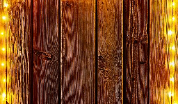 istock Christmas lights on wooden rustic background. 623438196