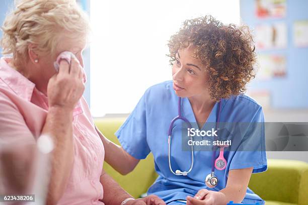 Hospital Doctor Chatting To Worried Patient Stock Photo - Download Image Now - Nurse, Death, Hospital