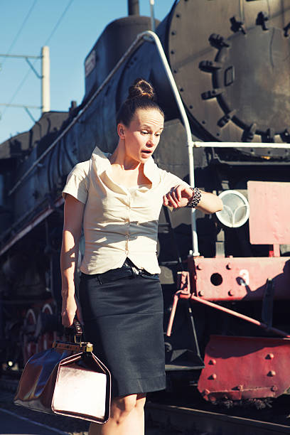 istock Woman on platform near the retro train 623439090