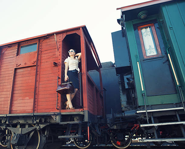 istock Woman with a suitcase standing on the train 623439406