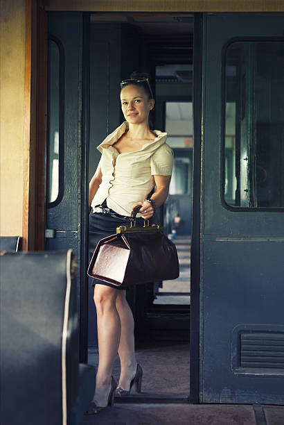 istock Woman with a suitcase in the retro train 623441104