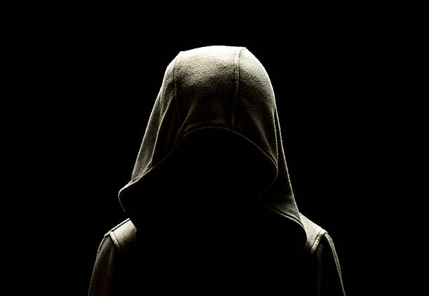 istock unrecognizable person dressed in hooded jacket in the dark 623444088