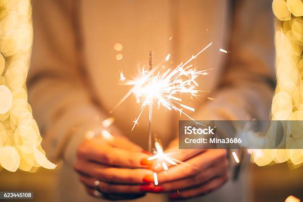 Woman Holding Sparkler Stock Photo - Download Image Now - Sparkler - Firework, Christmas, Celebration