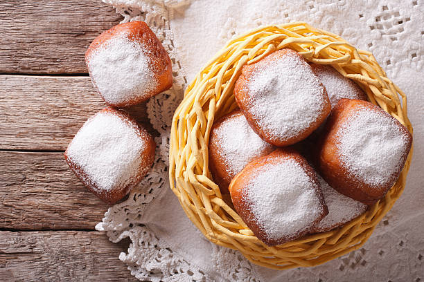 fried donuts square beignets in the basket. Horizontal top view fried donuts square beignets in the basket on the table. Horizontal top view beignet stock pictures, royalty-free photos & images
