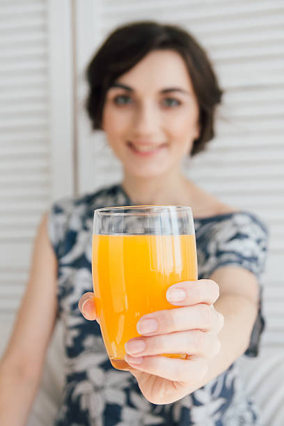 istock Girl drinking orange juice at Breakfast in bed 623446598