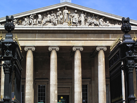 Tourists near Hyde Park Screen on Piccadilly Arcade in City of Westminster, London. This Grade I listed building was built by Decimus Burton in the late 1820s and is also known as the Grand Approach.