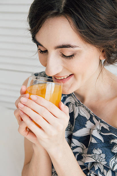 istock Girl drinking orange juice at Breakfast in bed 623447604