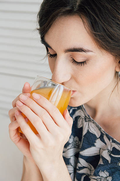 istock Girl drinking orange juice at Breakfast in bed 623447984