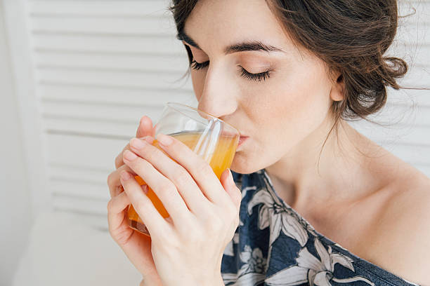 istock Girl drinking orange juice at Breakfast in bed 623448356