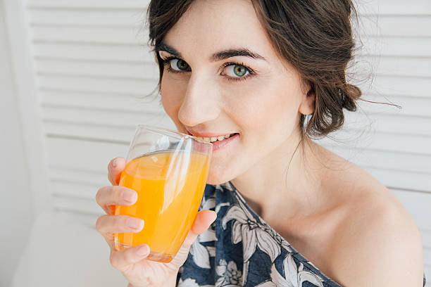 istock Girl drinking orange juice at Breakfast in bed 623448572