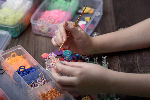 istock children's hands are weaving figures out of colored rubbers 623449218
