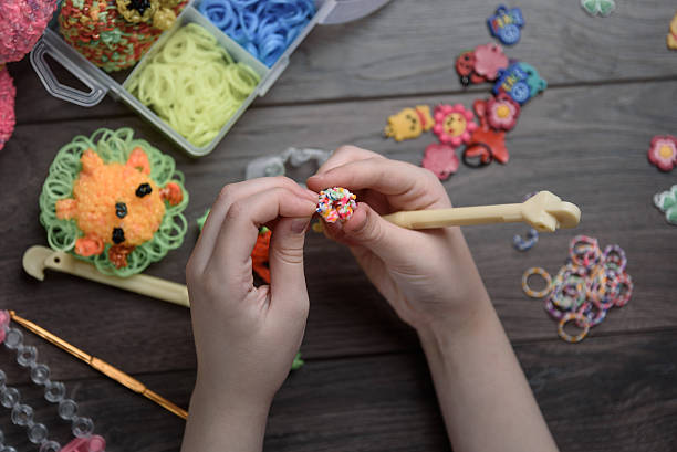 istock children's hands are weaving figures out of colored rubbers 623449518
