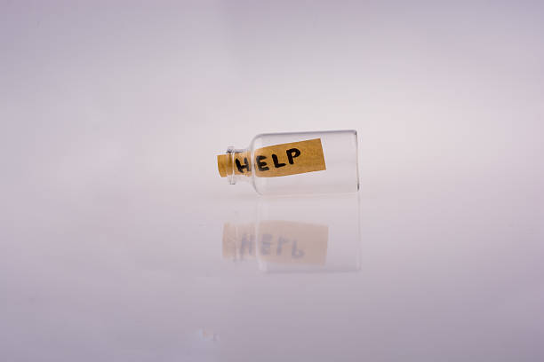 istock Help word on a piece paper  in a bottle 623450906