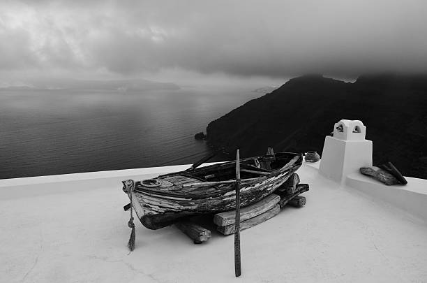 Santorini old decoration wooden boat with a sunset background.